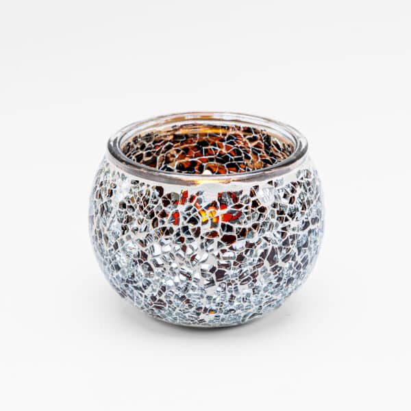 Theelichthouder DORSETTO 9 cm Orange is een ronde glazen kandelaar met een decoratief mozaïek van zilveren en amberkleurige reflecterende stukjes voor een stijlvolle, gestructureerde look.