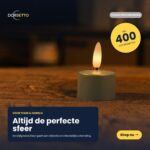Ein Set aus 12 olivgrünen LED-Teelichtern mit bis zu 400 Stunden Brenndauer und Fernbedienung steht auf einem Holztisch und sorgt für ein stimmungsvolles Ambiente. Die Schaltfläche "Shop nu" erscheint unten rechts.